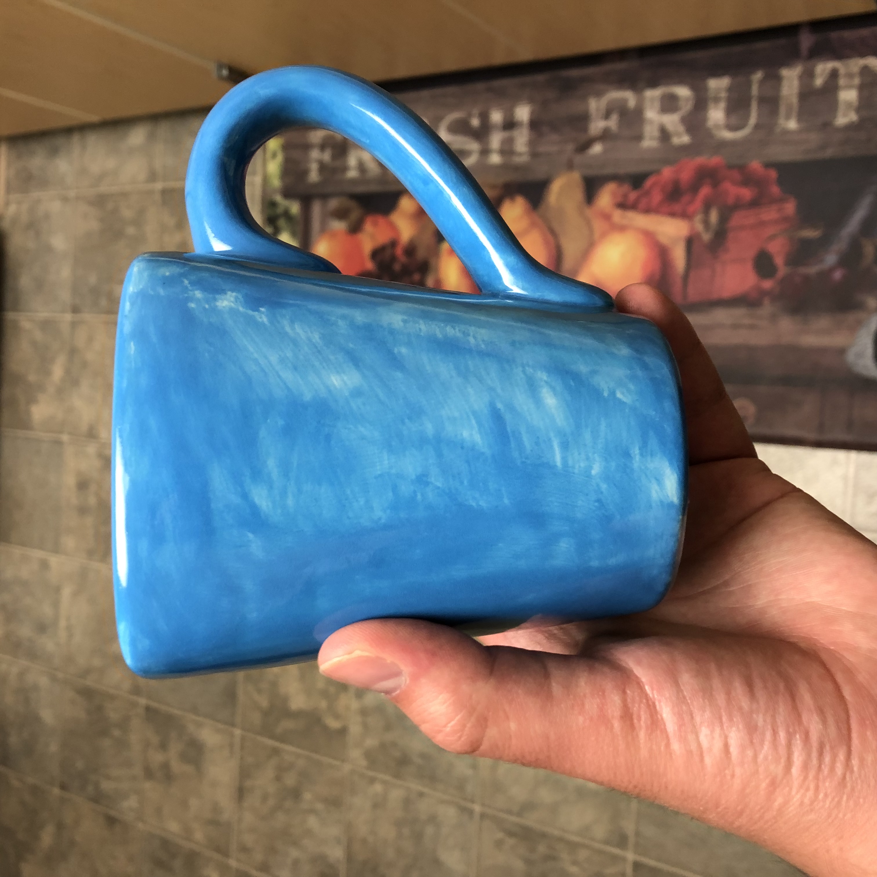 A poorly-painted blue mug